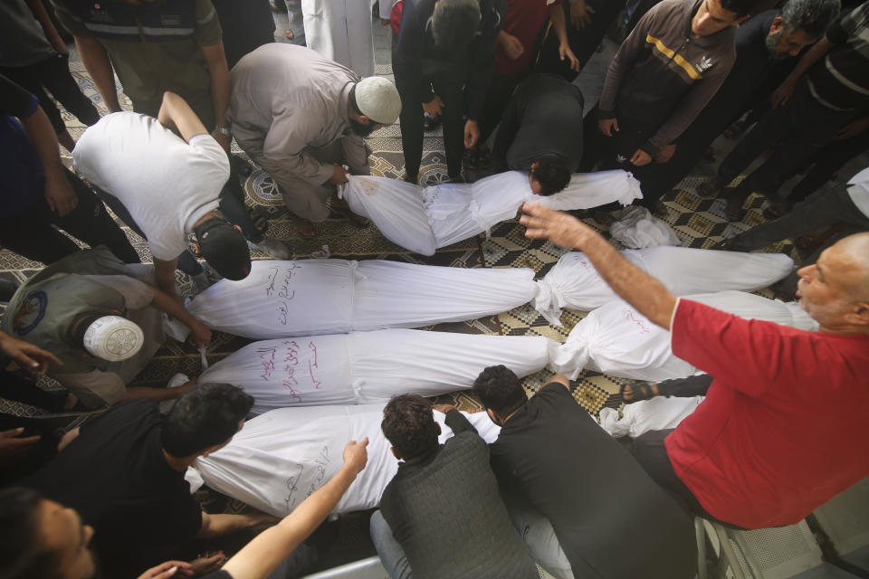 Palestinians carry the bodies of the Zanon family, who were killed in Israeli airstrikes in Rafah, Gaza Strip, Saturday, Oct. 14, 2023. (AP Photo/Hatem Ali)