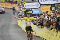 Slovenia's Tadej Pogacar, wearing the overall leader's yellow jersey, celebrates as he crosses the finish line to win the eighteenth stage of the Tour de France cycling race over 129.7 kilometers (80.6 miles) with start in Pau and finish in Luz Ardiden, France,Thursday, July 15, 2021. (AP Photo/Christophe Ena)