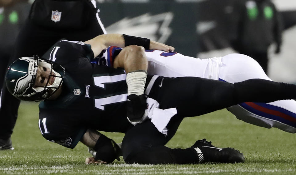 Philadelphia Eagles' Carson Wentz is tackled by New York Giants' Olivier Vernon. (AP)