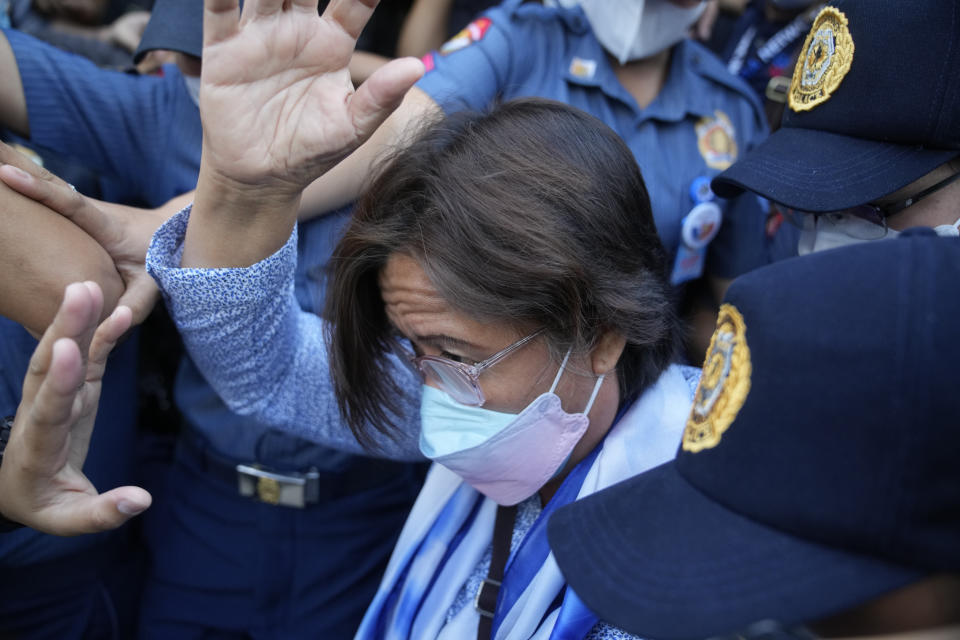 Detained former opposition Sen. Leila de Lima walks under tight security after she went for a court hearing which was later postponed in Muntinlupa, Philippines, Monday, Oct. 10, 2022. Human rights activists pressed their call Monday for the immediate release of de Lima after she was taken hostage in a rampage by three Muslim militants in a failed attempt to escape from a maximum-security jail. (AP Photo/Aaron Favila)