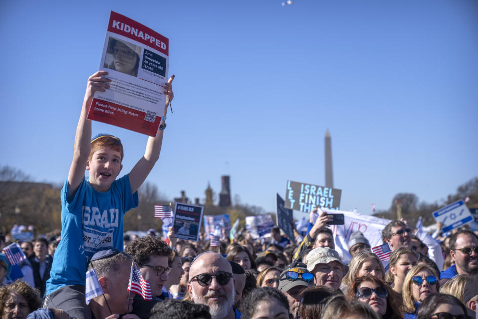 Participants hold signs as they stand on the National Mall at the March for Israel on Tuesday, Nov. 14, 2023, in Washington. (AP Photo/Mark Schiefelbein)