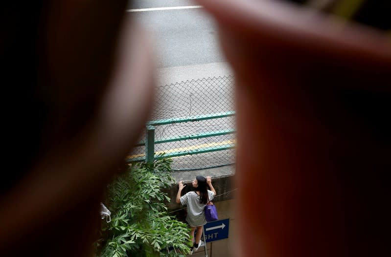 A protester tries to leave the campus of the Hong Kong Polytechnic University