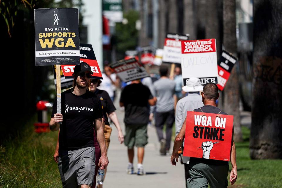 <p>Mario Tama/Getty </p> SAG-AFTRA members support striking WGA members