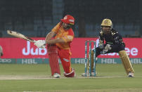 Quetta Gladiators batsman Dawid Milan hits a boundary as Islamabad United wicketkeeper Sarfaraz Ahmed looks on during the Super League opening match at National Stadium in Karachi, Pakistan, Thursday, Feb. 20, 2020. (AP Photo/Fareed Khan)