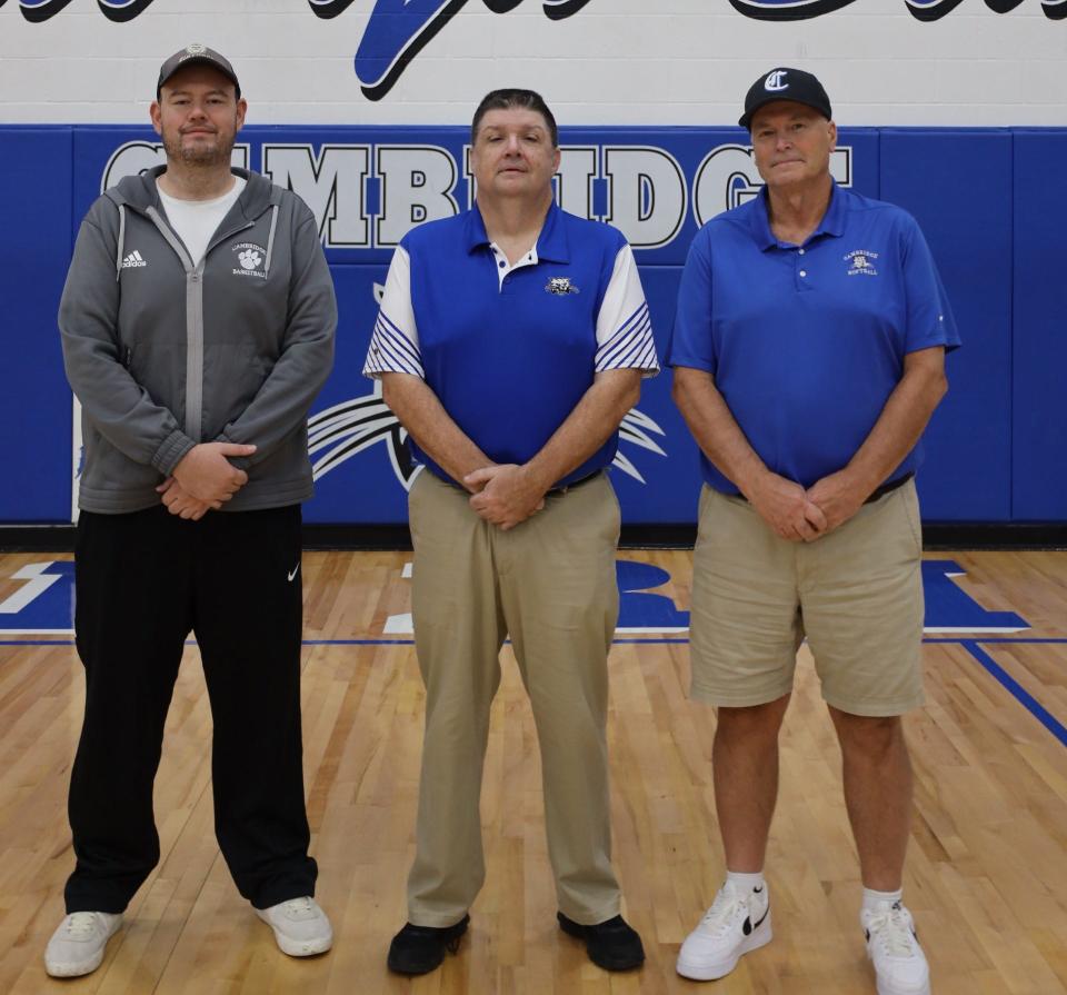 Veteran Cambridge boys basketball statistician and historian Ray Simms, is flanked by Cambridge head boys basketball coach Kyle Pertuset, left, and CHS head softball coach Bob Shepard. Simms is entering his 27th year keeping track of Cambridge High athletes stats and records.