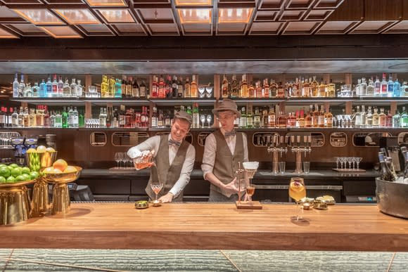 Two men are serving drinks at the new cocktail bar inside the New York Roastery.