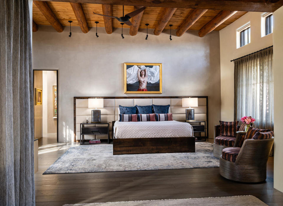 A bedroom marries modernized furnishings with hallmarks of Santa Fe style and a striking art collection