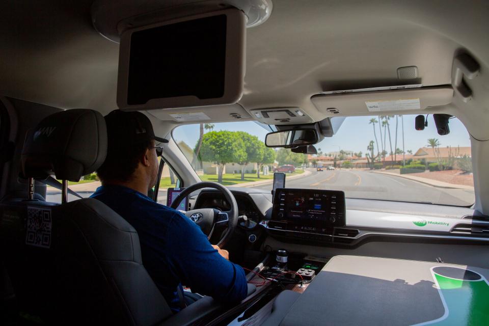 Spencer Jay sits in the safety driver's seat of a May Mobility autonomous vehicle in Sun City on Thursday, May 4, 2023.