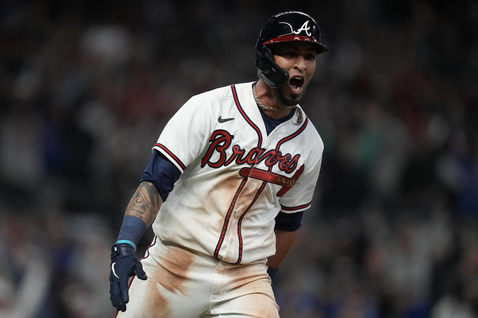 Atlanta Braves' Eddie Rosario celebrates after hitting a game winning RBI single during the ninth inning against the Los Angeles Dodgers in Game 2 of baseball's National League Championship Series Sunday, Oct. 17, 2021, in Atlanta. The Braves defeated the Dodgers 5-4 to lead the series 2-0 games. (AP Photo/Ashley Landis)