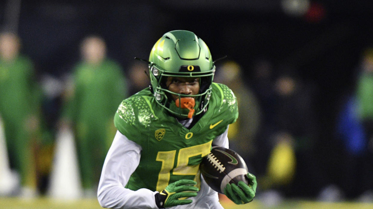 Oregon wide receiver Tez Johnson (15) runs after a catch against Oregon State during the first half of an NCAA college football game Saturday, Nov. 24, 2023, in Eugene, Ore. Oregon won 31-7. (AP Photo/Mark Ylen)