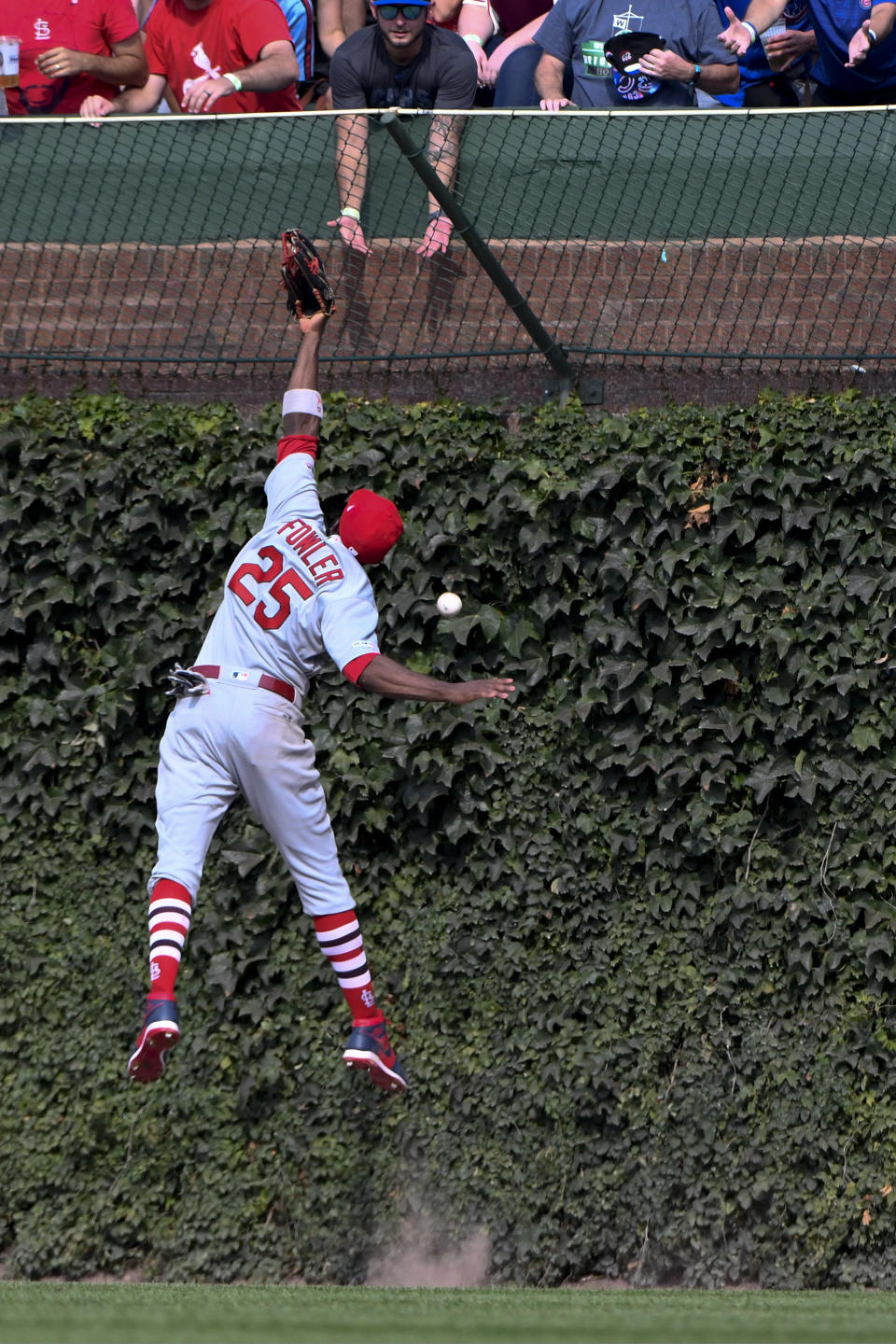 St. Louis Cardinals right fielder Dexter Fowler (25) tries to make a play on the ball hit by Chicago Cubs' Nicholas Castellanos during the fifth inning of a baseball game Friday, Sept. 20, 2019, in Chicago. (AP Photo/Matt Marton)