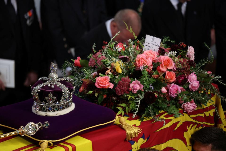 The coffin of Queen Elizabeth II, draped in the Royal Standard with the Imperial State Crown and the Sovereign's sceptre, is carried out of Westminster Abbey, during the State Funeral of Queen Elizabeth II, held in London on September 19, 2022. (Photo by PHIL NOBLE / POOL / AFP) (Photo by PHIL NOBLE/POOL/AFP via Getty Images)