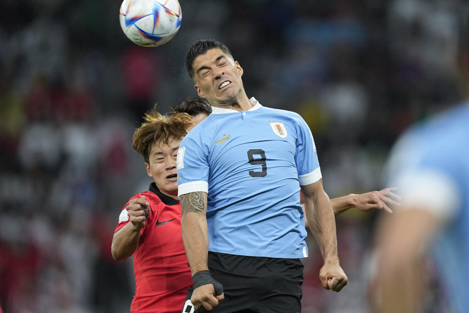 Uruguay's Luis Suarez, right, and South Korea's Kim Jin-su go for a header during the World Cup group H soccer match between Uruguay and South Korea, at the Education City Stadium in Al Rayyan , Qatar, Thursday, Nov. 24, 2022. (AP Photo/Martin Meissner)