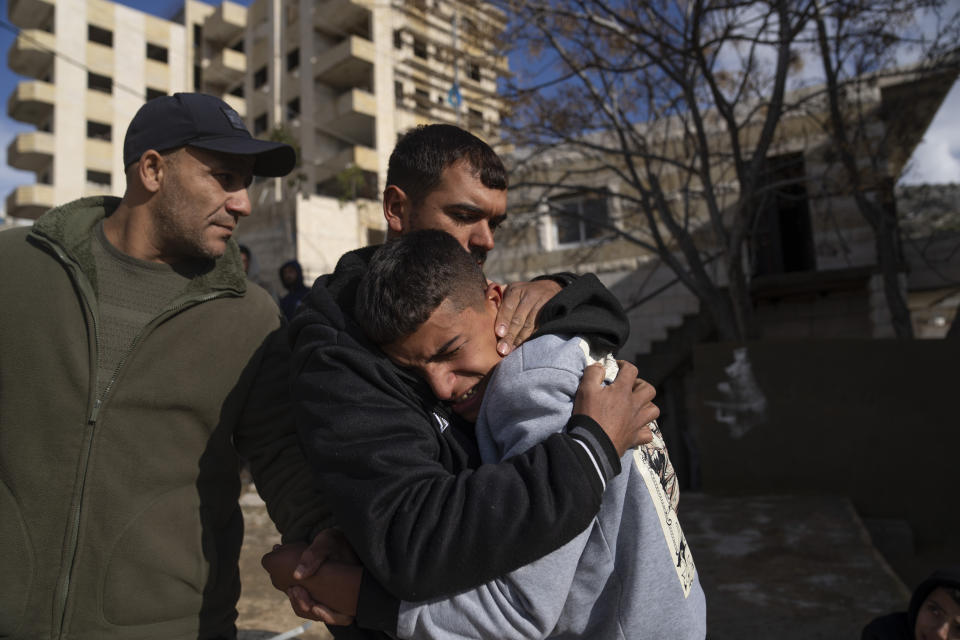 Suleiman Hamed, 14, right, brother of Palestinian Abdel Rahman Hamed, 18, cries wile comforted by a relative during his funeral in the West Bank town of Silwad, Monday, Jan. 29, 2024. Palestinian authorities say five Palestinians have been killed by Israeli forces in separate shootings across the occupied West Bank on Monday, including Hamed, who was killed during clashes with Israeli border police at his home village of Silwad. (AP Photo/Nasser Nasser)