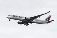 FILE - In this Nov. 7, 2019, file photo, a Qatar Airways jet approaches Philadelphia International Airport in Philadelphia. Qatar apologized Wednesday, Oct. 28, 2020, after authorities forcibly examined female passengers from a Qatar Airways flight to Australia to try to identify who might have given birth to a newborn baby found abandoned at the airport earlier this month. (AP Photo/Matt Rourke, File)