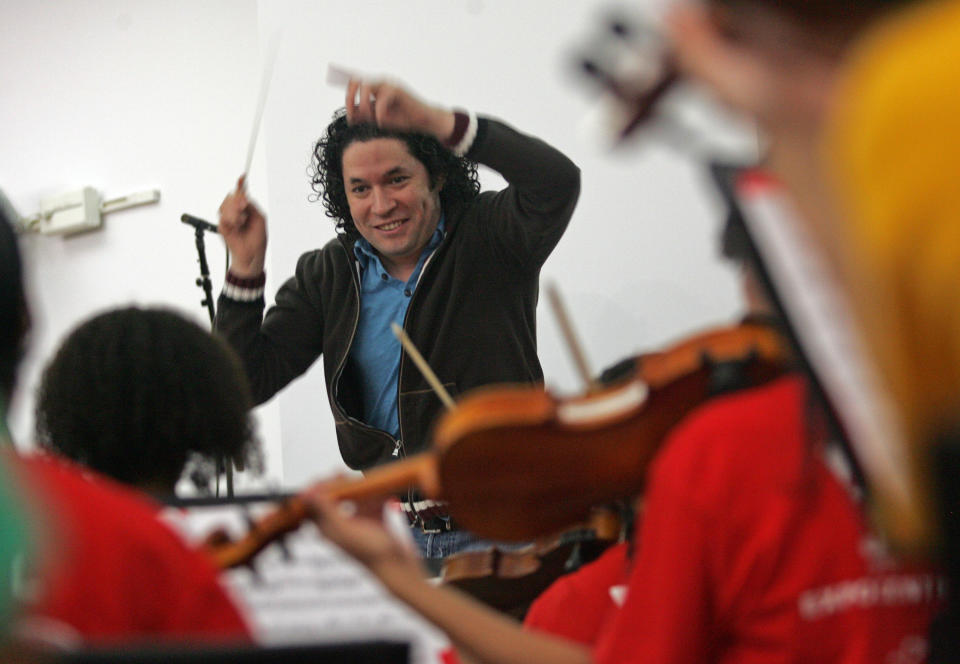 FILE - In this Oct. 29, 2011 file photo, conductor Gustavo Dudamel rehearses the Youth Orchestra of Los Angeles at YOLA EXPO Center Chamber Orchestra in Choral Hall at Walt Disney Concert Hall in Los Angeles. Dudamel is facing the heat in his native Venezuela for not speaking out against embattled President Nicolas Maduro while holding a series of high-profile concerts in Caracas, Venezuela in February 2014. (AP Photo/Ringo H.W. Chiu, File)