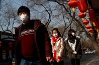 People wear face masks in a street after the novel coronavirus outbreak in Beijing