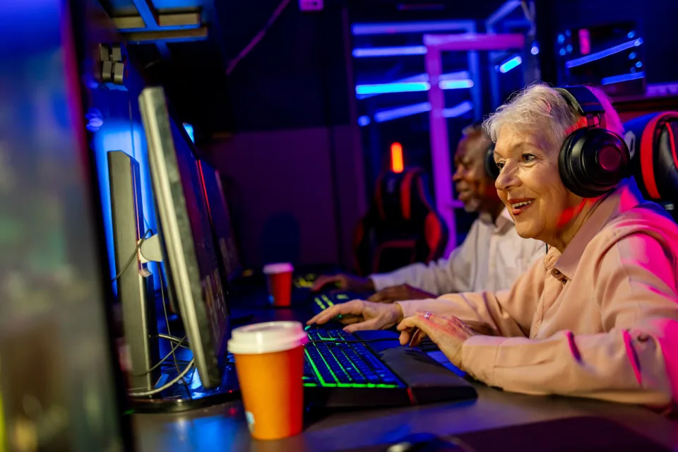 Cheerful senior couple having fun while playing video game.