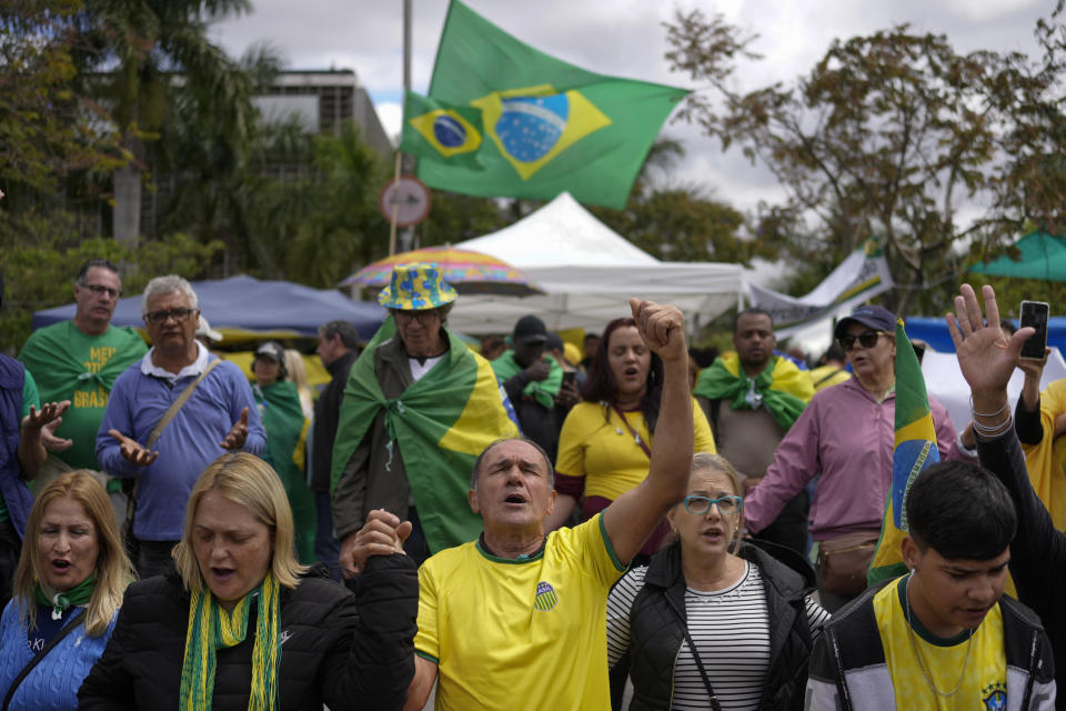 Supporters of outgoing President Jair Bolsonaro protest against his defeat in the country's presidential runoff, outside a military base in Sao Paulo, Brazil, Thursday, Nov. 3, 2022. Some supporters are calling on the military to keep Bolsonaro in power, even as his administration signaled a willingness to hand over the reins to his rival, President-elect Luiz Inacio Lula da Silva. (AP Photo/Matias Delacroix)