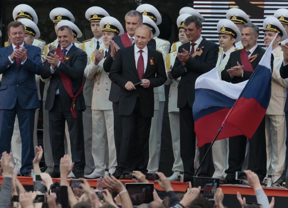 FILE - Russian President Vladimir Putin, center, is greeted by people after speaking at a gala concert marking the Victory Day in Sevastopol, Crimea, on May 9, 2014. Putin on Friday Dec. 8, 2023 moved to prolong his repressive and unyielding grip on Russia for another six years, announcing his candidacy in the 2024 presidential election that he is all but certain to win.(AP Photo/Ivan Sekretarev, File)