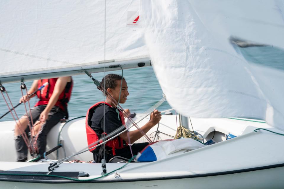 Ari Boyce, 13, of Farmington Hills, right, sails on the Detroit River as he participates in the Challenge the Wind program on Thursday, July 20, 2023, from the banks of the Belle Isle Boat House.