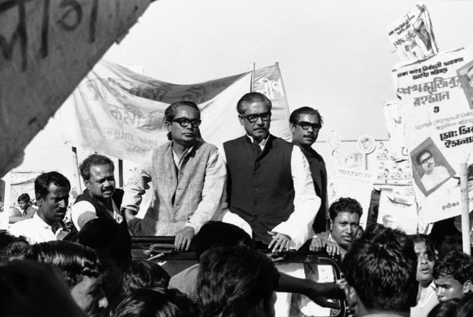 FILE- In this Dec. 7, 1970, file photo, Sheikh Mujibur Rahman, center on Rostrum, leader of East Pakistan's powerful Awami League, addresses an election rally in Dacca, East Pakistan. A watershed moment occurred in 1970 amid strikes and rising hostilities, when East Pakistan’s Awami League, led by Bengali politician Sheikh Mujibur Rahman, swept the polls in a national election. The government rejected the results, spawning a civil disobedience movement. On March 26, 1971, Bangladesh declared independence, sparking the nine-month war. Pakistan launched a military operation to stop the move to independence, while India joined on the side of what is now Bangladesh. Pakistani forces surrendered on Dec. 16, 1971. (AP Photo/Dennis Lee Royle, File)