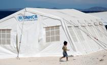 A child runs in front of a tent at a new temporary camp for migrants and refugees, on the island of Lesbos