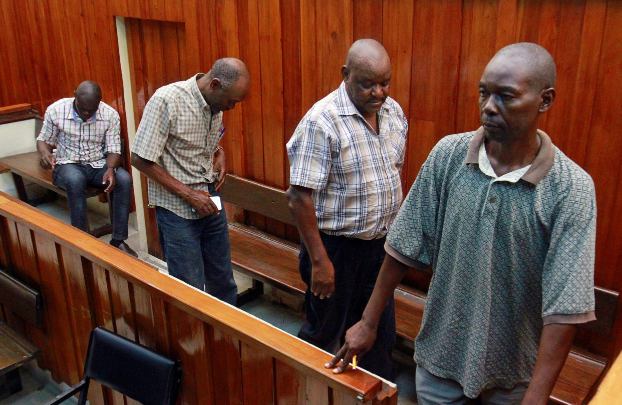 The four Kenyan police officers accused of the killing Alexander Monson are brought in to the dock during an earlier hearing. (Reuters)