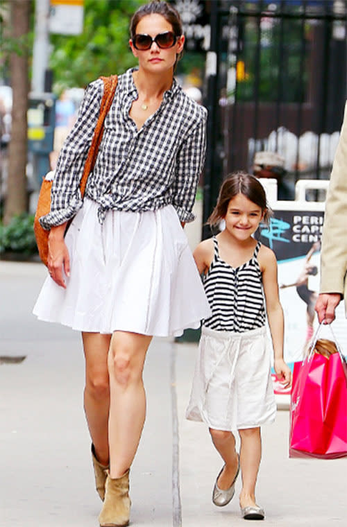 Katie Holmes and Suri Cruise walked the streets of New York City hand-in-hand in white skirts and black and white shirts.