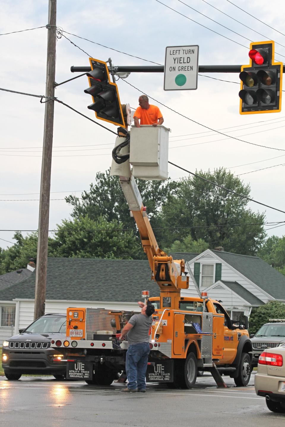 A Fremont city crew works on a traffic light at Rawson Avenue and North Street that was damaged in a storm that hit Fremont on July 1.