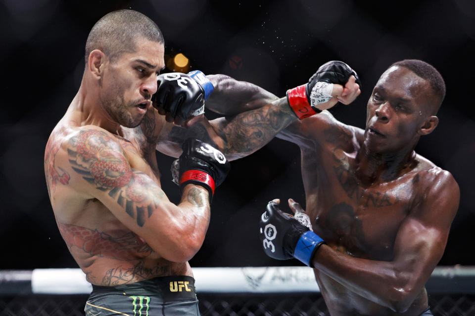 MIAMI, FLORIDA - APRIL 08: Alex Pereira of Brazil and Israel Adesanya of Nigeria exchange strikes during their Middleweight fight at Kaseya Center on April 08, 2023 in Miami, Florida. (Photo by Carmen Mandato/Getty Images)