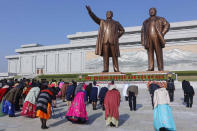 People visit the statues of their late leaders Kim Il Sung and Kim Jong Il on the occasion of the Day of the Sun, the birth anniversary of Kim Il Sung, in Pyongyang, North Korea Thursday, April 15, 2021. (AP Photo/Cha Song Ho)