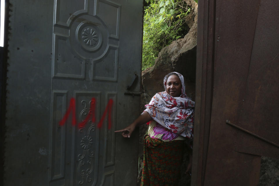 Zouriati M, of France, shows the number painted on her door in the Talus 2 district of Koungou, in the French Indian Ocean territory of Mayotte, Saturday, April 22, 2023. France is facing a migration quagmire on the island territory of Mayotte off Africa’s east coast. The government sent in 2,000 troops and police to carry out mass expulsions, destroy slums and eradicate violent gangs. But the operation has become bogged down and raised concerns of abuse, aggravating tensions between local residents and immigrants from the neighboring country of Comoros. (AP Photo/Gregoire Merot)