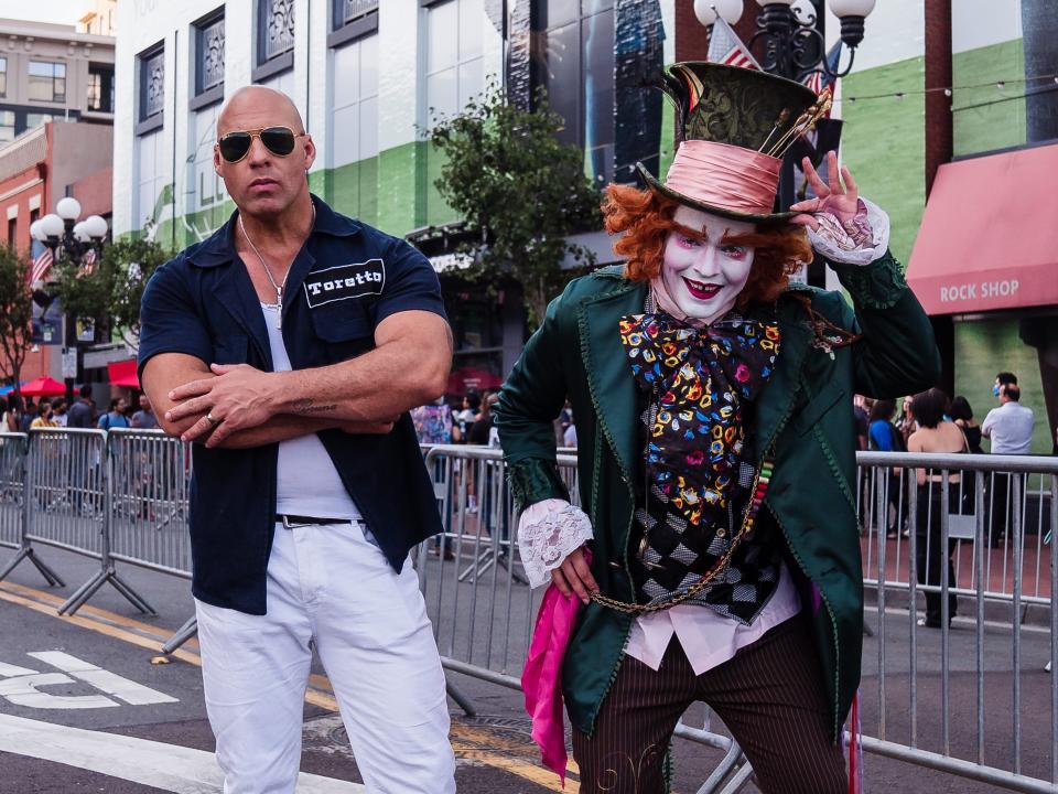 Cosplayers dressed as Dominic Toretto from the "Fast and Furious" movies and the Mad Hatter from "Alice in Wonderland."