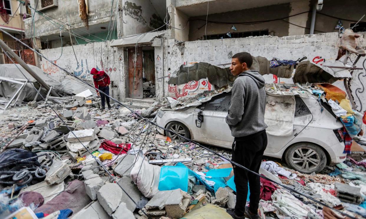 <span>People inspect damage and recover items from their homes following Israeli air strikes in Gaza city on Tuesday.</span><span>Photograph: Ahmad Hasaballah/Getty Images</span>