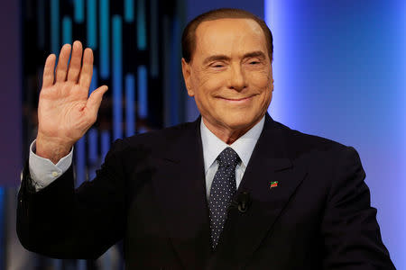 FILE PHOTO: Italy's former Prime Minister Silvio Berlusconi waves before the taping of the television talk show "8 e mezzo" (8 and half) in Rome, Italy February 21, 2018. REUTERS/Max Rossi/File Photo