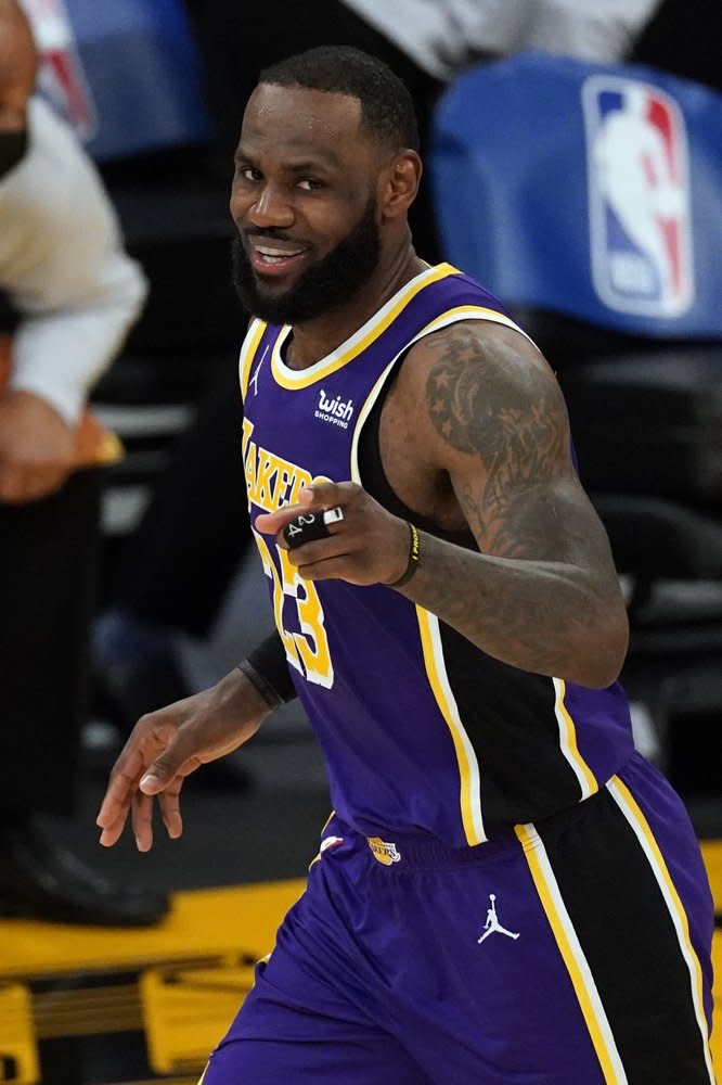 Los Angeles Lakers forward LeBron James (23) points at a team mate during the second half of an NBA basketball game against the Portland Trail Blazers Friday, Feb. 26, 2021, in Los Angeles. (AP Photo/Mark J. Terrill)