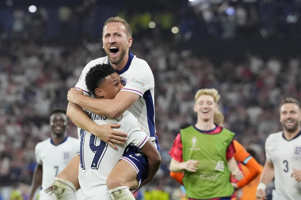 England's Harry Kane celebrates in the arms of teammate Ollie Watkins at the end of a semifinal match between the Netherlands and England at the Euro 2024 soccer tournament in Dortmund, Germany, Wednesday, July 10, 2024. England won 2-1. (AP Photo/Martin Meissner)
