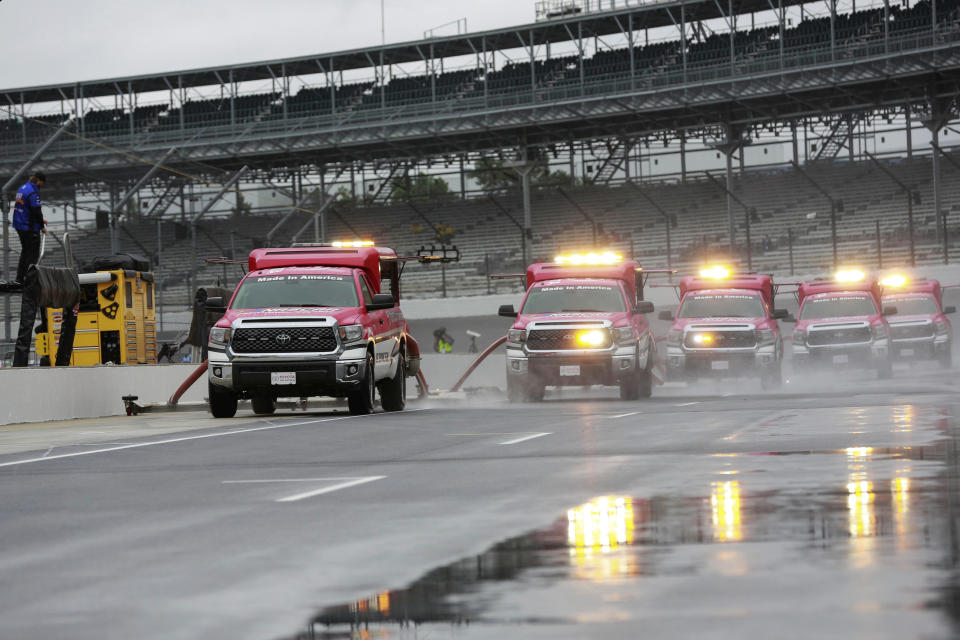 Track driers work to dry the pit lane before the NASCAR Brickyard 400 auto race at Indianapolis Motor Speedway, in Indianapolis Sunday, Sept. 9, 2018. (AP Photo)