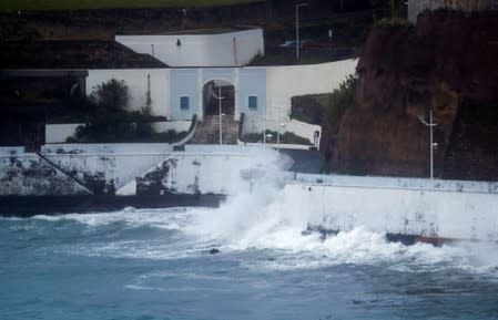 Waves crash on a wall at the port of Angra do Heroismo in Azores