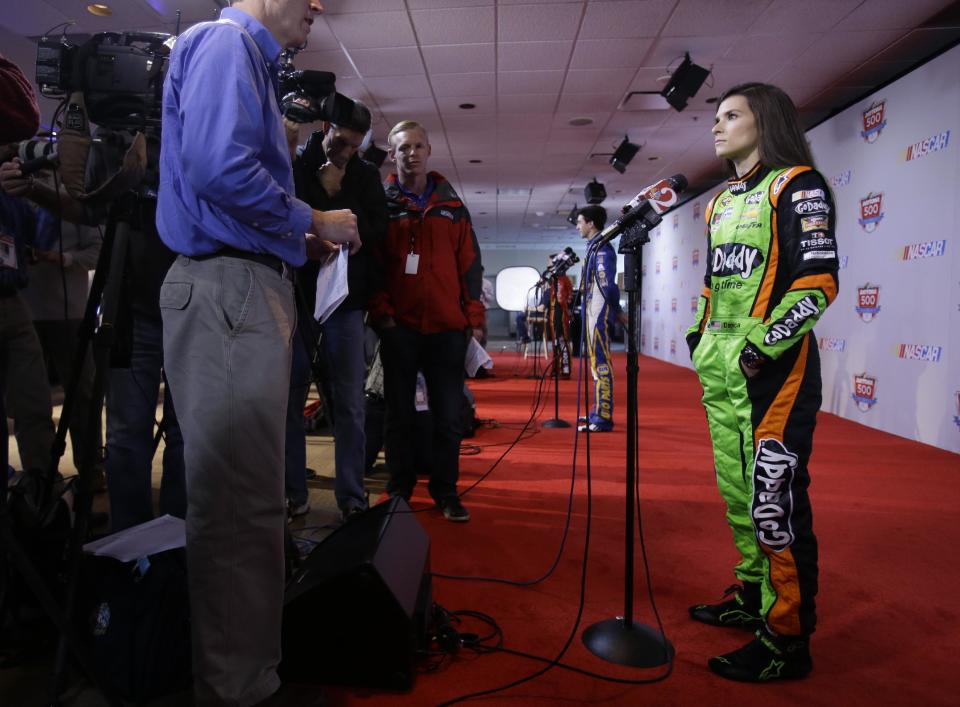 Driver Danica Patrick, right, answers questions during NASCAR auto racing media day at Daytona International Speedway in Daytona Beach, Fla., Thursday, Feb. 13, 2014. (AP Photo/John Raoux)