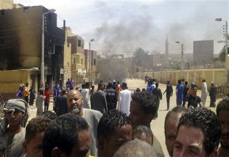 Smoke rises after clashes between rival families of the Nubian and the Arab Beni Helal clans in the southern city of Aswan, south of Cairo April 6, 2014. REUTERS/Al Youm Al Saabi Newspaper