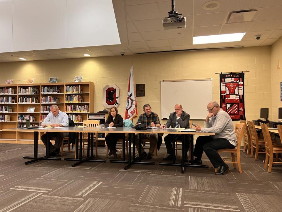 Members of the Orrville City Schools Board of Education listen to parents' concerns about new curriculum.