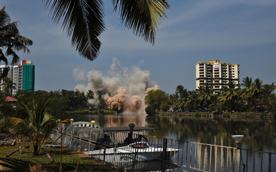 Alpha Serene, a water-front residential apartment, is razed to the ground by controlled implosion in Kochi, India, Saturday, Jan. 11. 2020. Authorities in southern Kerala state on Saturday razed down two high-rise luxury apartments using controlled implosion in one of the largest demolition drives in India involving residential complexes for violating environmental norms. (AP Photo/R S Iyer)