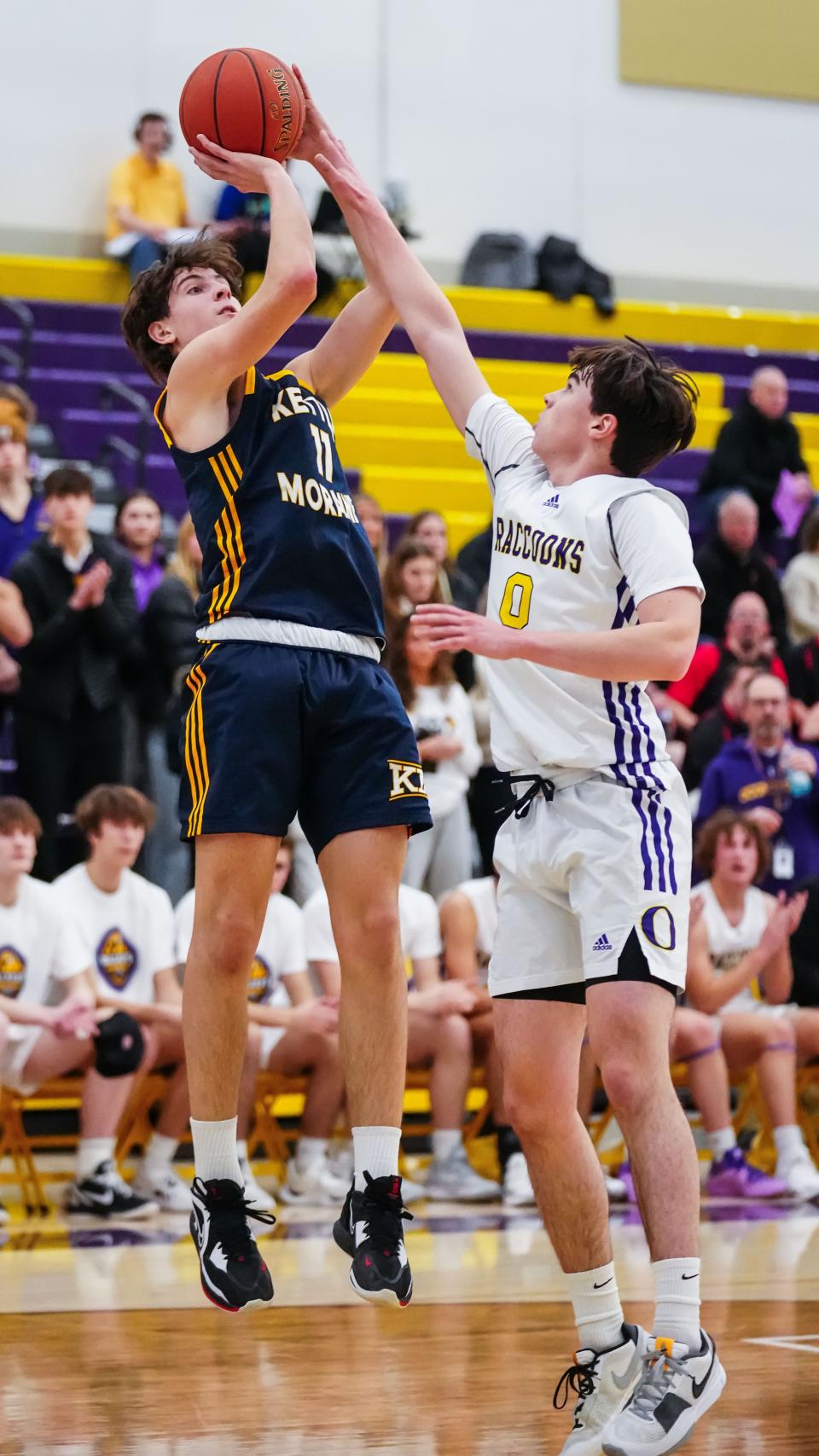 Kettle Moraine's Nathan Vuillaume (11) elevates for a shot over Oconomowoc's Lukas Hoffman (0) during the game at Oconomowoc, Tuesday, Jan. 16, 2024.