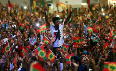 FILE PHOTO: A man cheers during celebrations for the return of Jawar Mohammed, U.S.-based Oromo activist and leader of the Oromo Protests, in Addis Ababa, Ethiopia August 5, 2018. REUTERS/Tiksa Negeri/File Photo