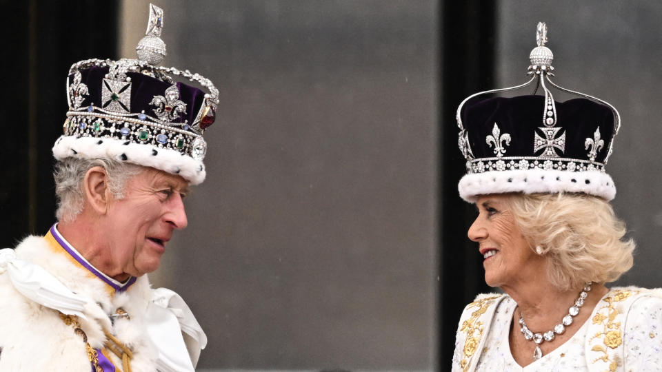 <p>Britain's King Charles III wearing the Imperial state Crown, and Britain's Queen Camilla wearing a modified version of Queen Mary's Crown chat on the Buckingham Palace balcony while viewing the Royal Air Force fly-past in central London on May 6, 2023, after their coronations. - The set-piece coronation is the first in Britain in 70 years, and only the second in history to be televised. Charles will be the 40th reigning monarch to be crowned at the central London church since King William I in 1066. (Photo by Oli SCARFF / AFP) (Photo by OLI SCARFF/AFP via Getty Images)</p> 