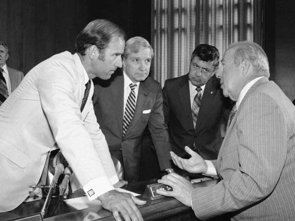 FILE - In this July 13, 1982, file photo Secretary of State designate George Shultz, right, speaks with members of the Senate Foreign Relations Committee prior to the start of the afternoon session of the panel on Capitol Hill in Washington. From left, Sen. Joseph Biden, D-Del.; Sen. Charles Percy, R-Ill., chairman of the panel and Sen. Edward Zorinsky, D-Neb.