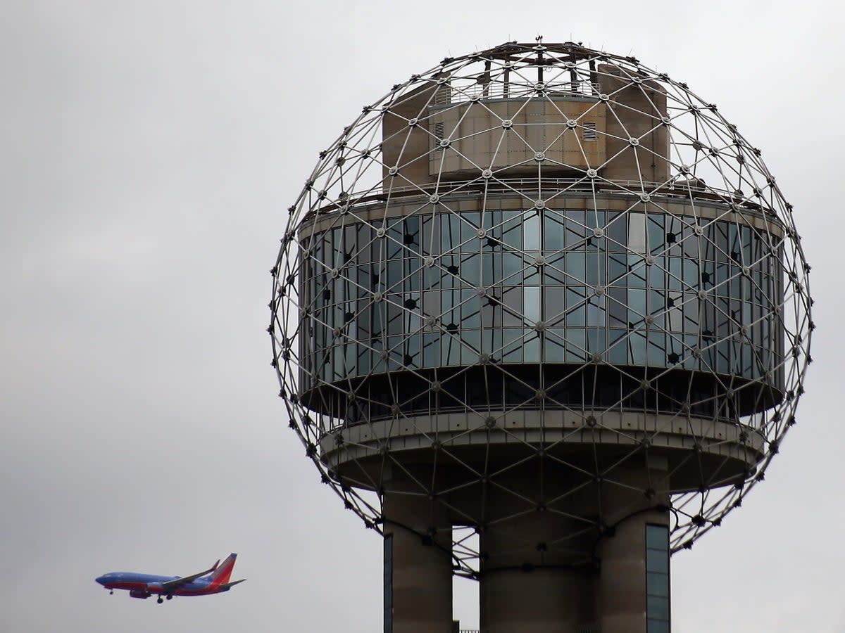 A Southwest Airline plane flies past Reunion Tower on 4 April, 2013 in Dallas, Texas (Getty Images)
