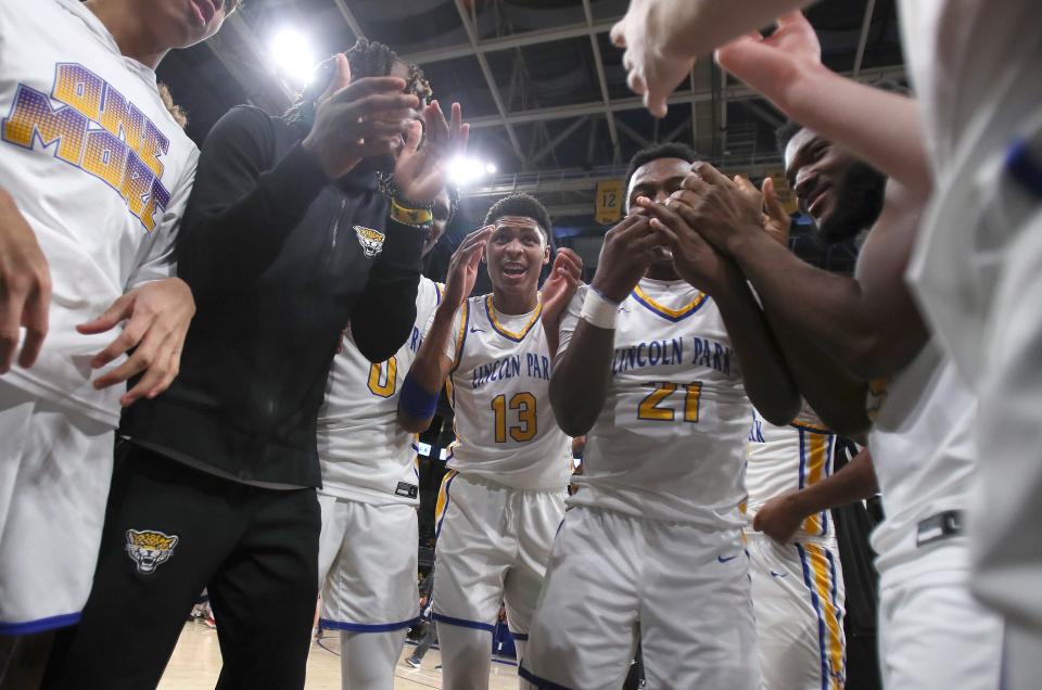 Lincoln Park's basketball team celebrates while in a huddle after defeating the North Catholic Trojans 78-68 and claiming the WPIAL 4A Title Friday night at the Petersen Events Center in Pittsburgh, PA.